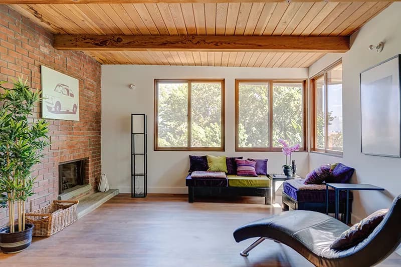 Mid-century Hollywood Hills living room with exposed beams and natural light